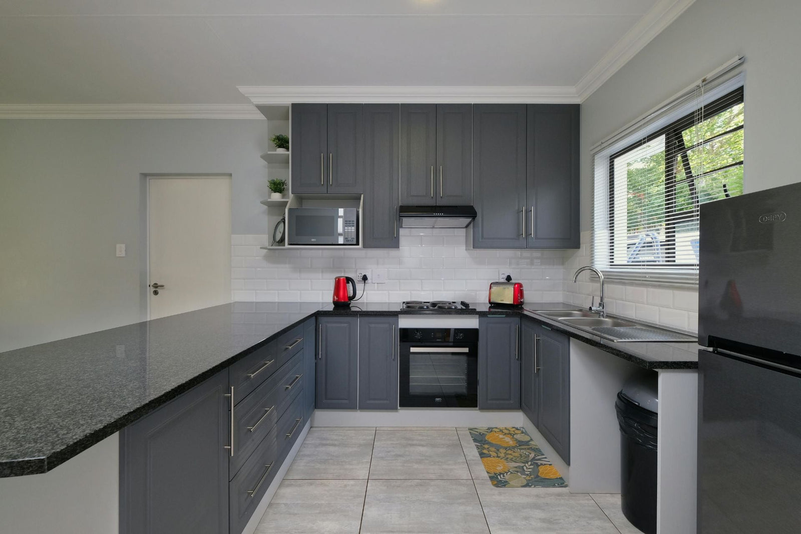 glass splashback grey kitchen