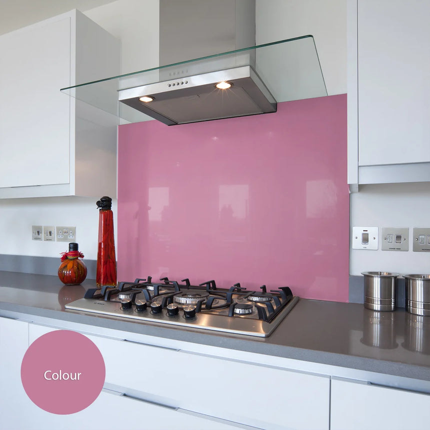 Berry pink glass splashback behind hob