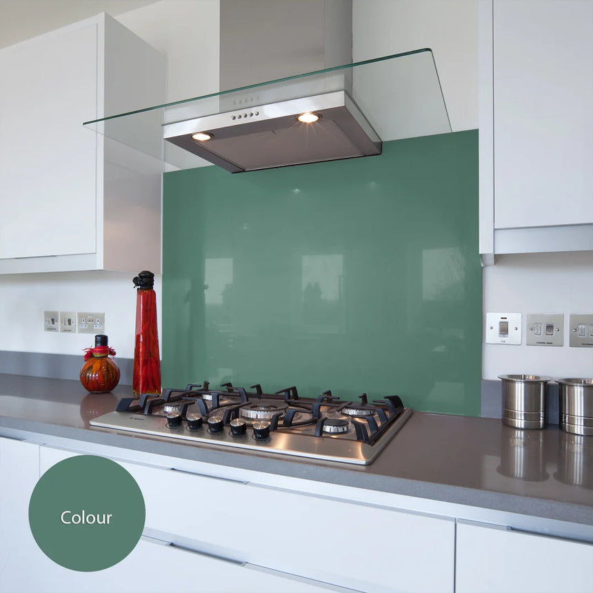 Emerald green glass splashback behind hob